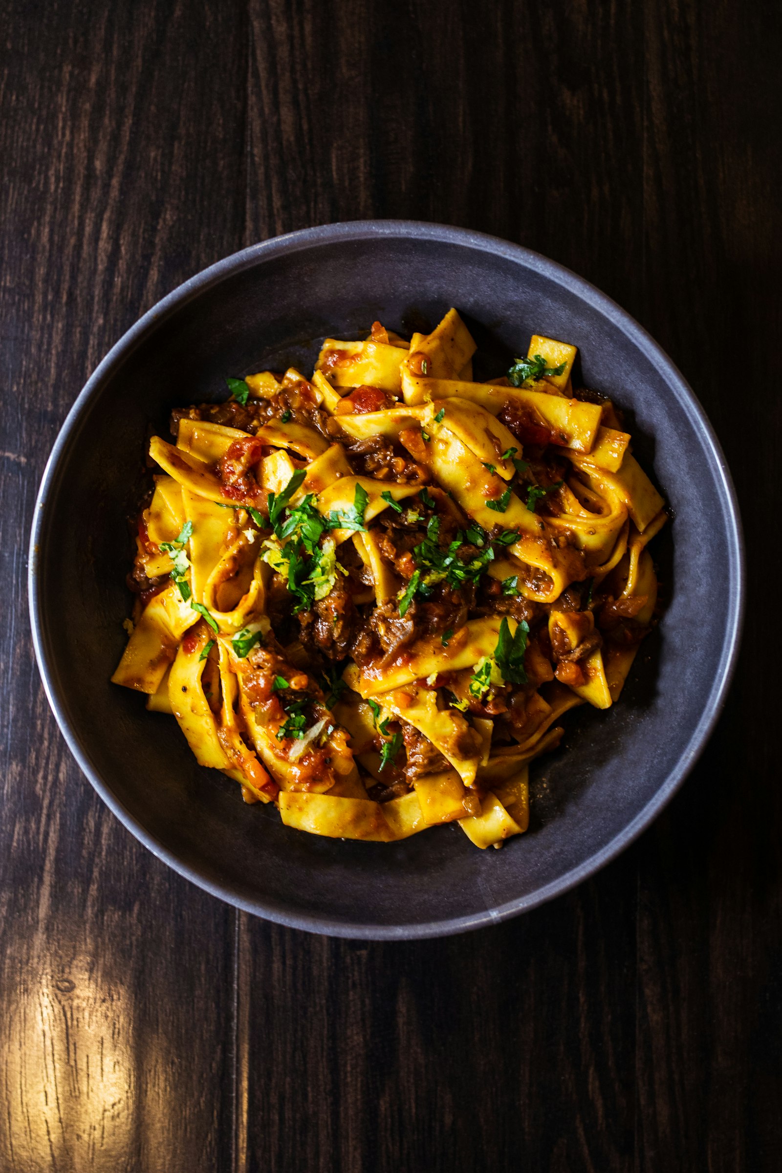 Bowl of tagliatelle coated in rich beef bolognese sauce with Parmesan