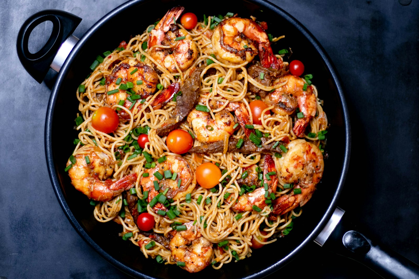 Linguine with shrimp scampi, lemon and parsley in a shallow bowl